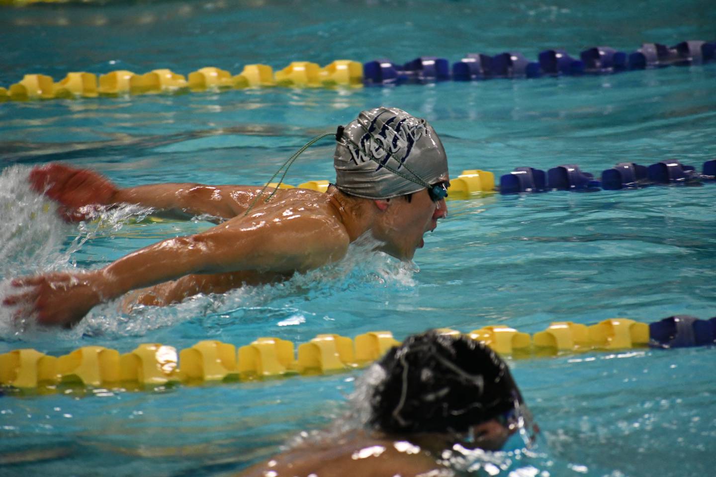 Eagle River's Jackson Delacruz competes in the 100 butterfly