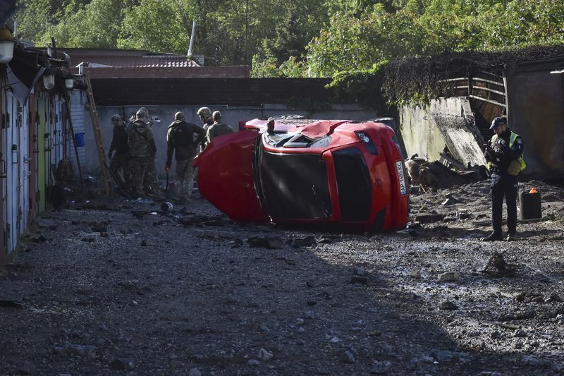 Police experts inspect the site of a Russian missile attack, in Zaporizhzhia, Ukraine, Wednesday, May 8, 2024. (AP Photo/Andriy Andriyenko)