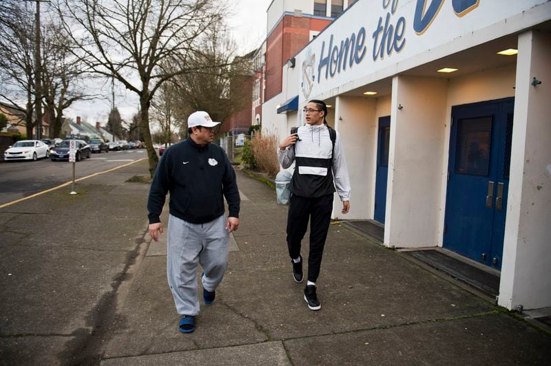 Roland Hepa, left, picks up his son, Kamaka, from basketball practice on Feb. 15, 2018, in Portland, Oregon. (Marc Lester / ADN)