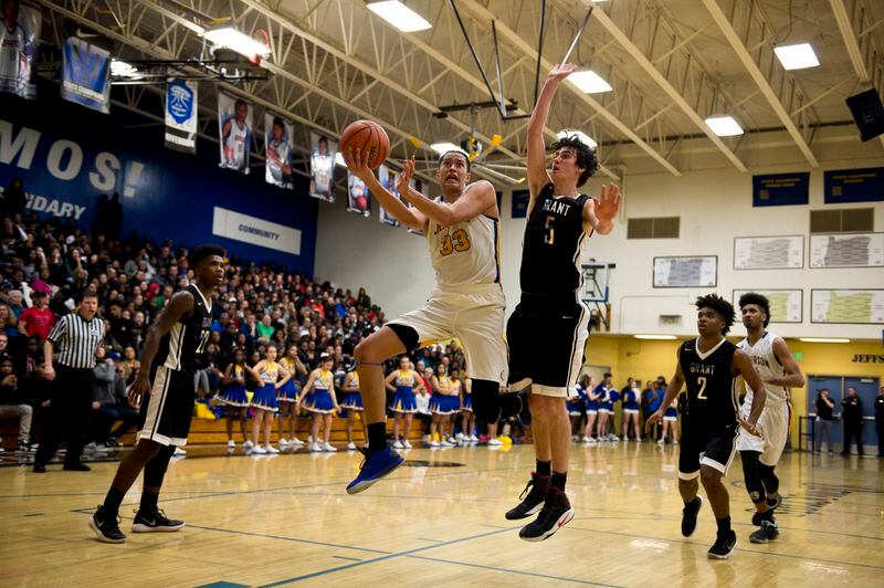 Jefferson High’s Kamaka Hepa drives toward the basket in a rivalry game against Grant High School in front of a full house on Feb. 16, 2018, in Portland. (Marc Lester / ADN)