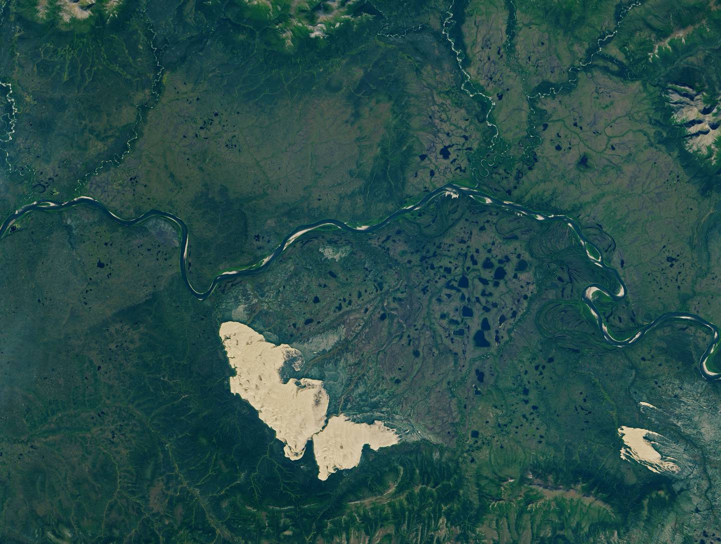 The Kobuk Sand Dunes, left, Little Kobuk Sand Dunes and the Kobuk River in northwestern Alaska as seen from space