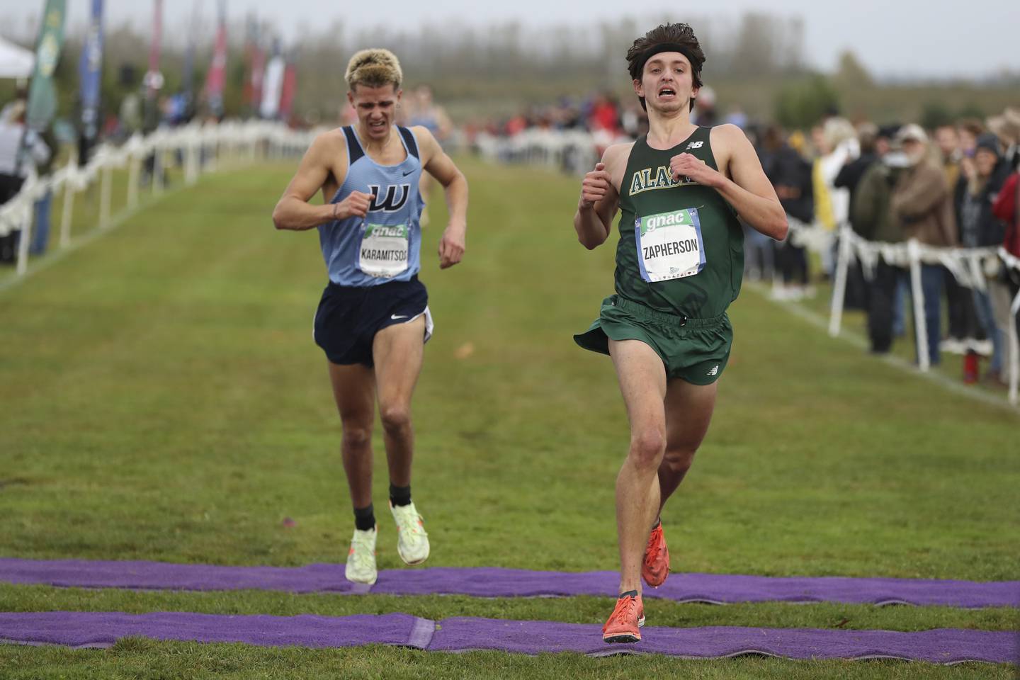 UAA's Michael Zapherson runs through the finish line during the Great Northwest Athletic Conference cross country championship