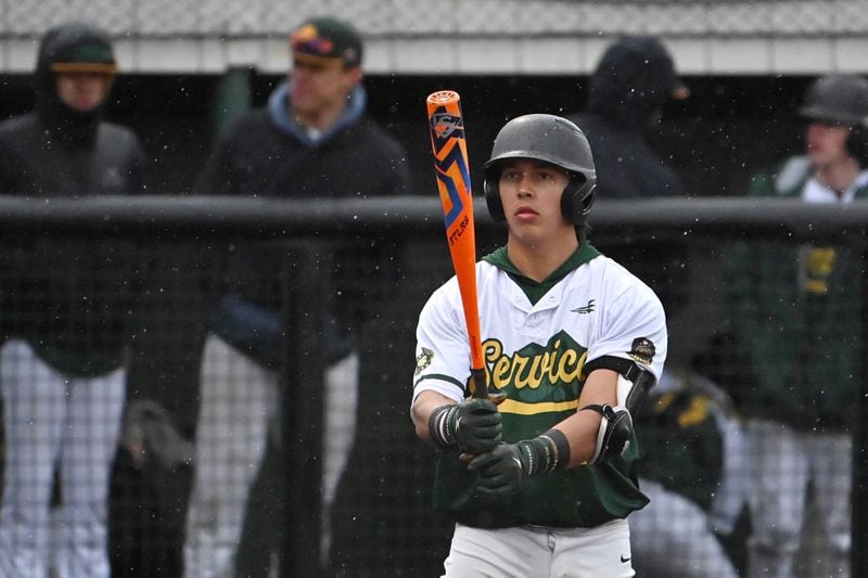 Service catcher Coen Niclai prepares to bat as snow and rain fell during the Cougars' 1-0 victory over the Dimond Lynx at Mulcahy Stadium on Wednesday evening. (Bill Roth / ADN)