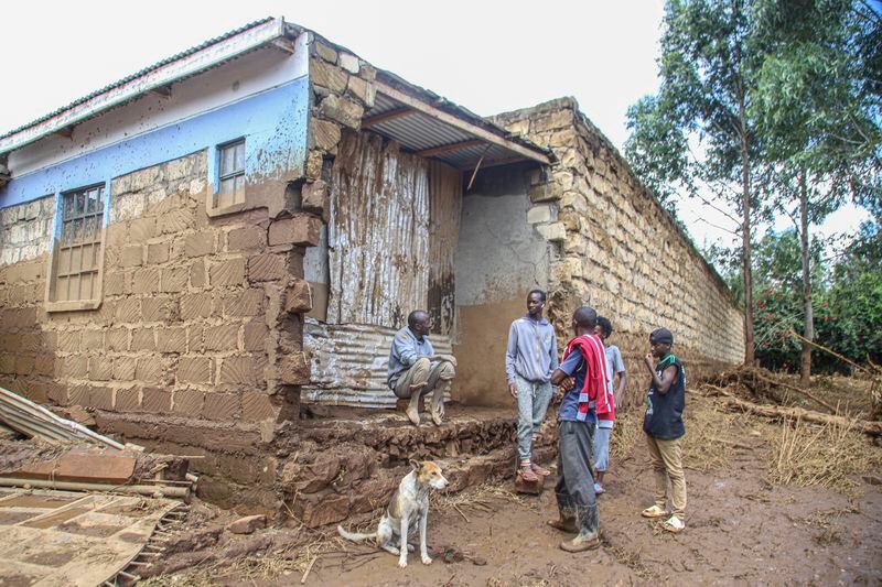 People gather near a damaged house after flooding in Kamuchiri Village Mai Mahiu, Nakuru County, Kenya, Monday, April. 29, 2024. (AP Photo/Patrick Ngugi)