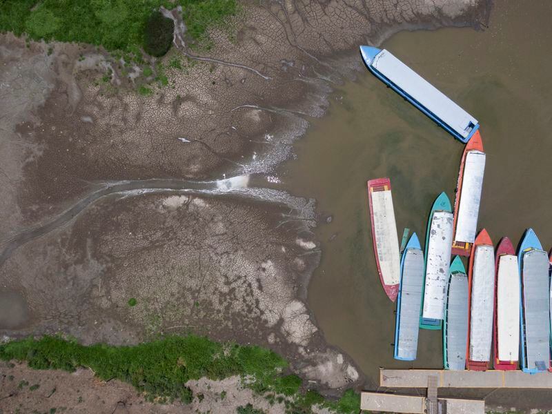 Boats are docked on the shore of Lake Patzcuaro, during a drought in Mexico, Thursday, April 18, 2024. Activist Juan Manuel Valenzuela estimates that 90% of the boats that used to fish and ferry tourists around are now out of service. (AP Photo/Armando Solis)