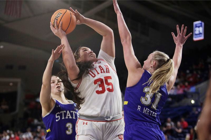 Utah forward Alissa Pili (35) shoots from between South Dakota State guard Madison Mathiowetz (3) and forward Brooklyn Meyer (31) during the first half of a first-round college basketball game in the women's NCAA Tournament in Spokane, Wash., Saturday, March 23, 2024. (AP Photo/Young Kwak)