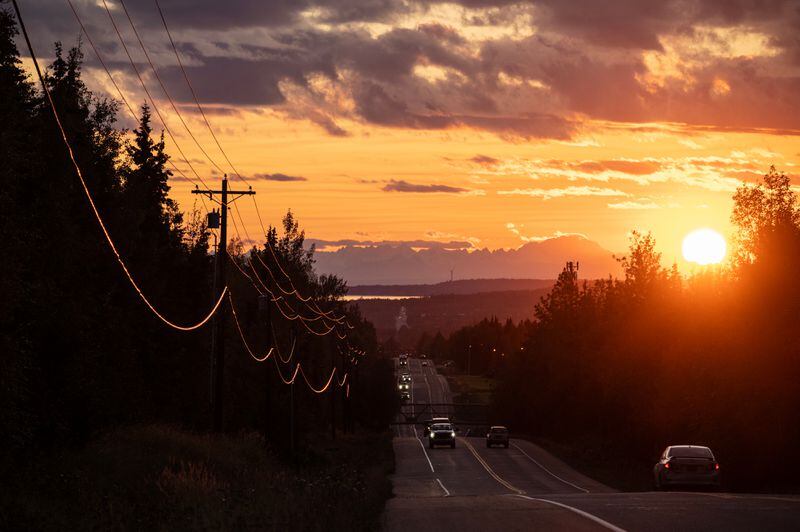 The sun sets in this westward view of Abbott Road in Anchorage on September 18, 2023. (Marc Lester / ADN)