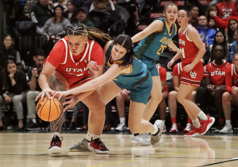 Utah’s Alissa Pili fights to keep control of the ball as UAA’s Kate Robertson attempts to steal the ball during their game at the Alaska Airlines Center in Anchorage on Saturday, Nov. 18, 2023. (Emily Mesner / ADN)