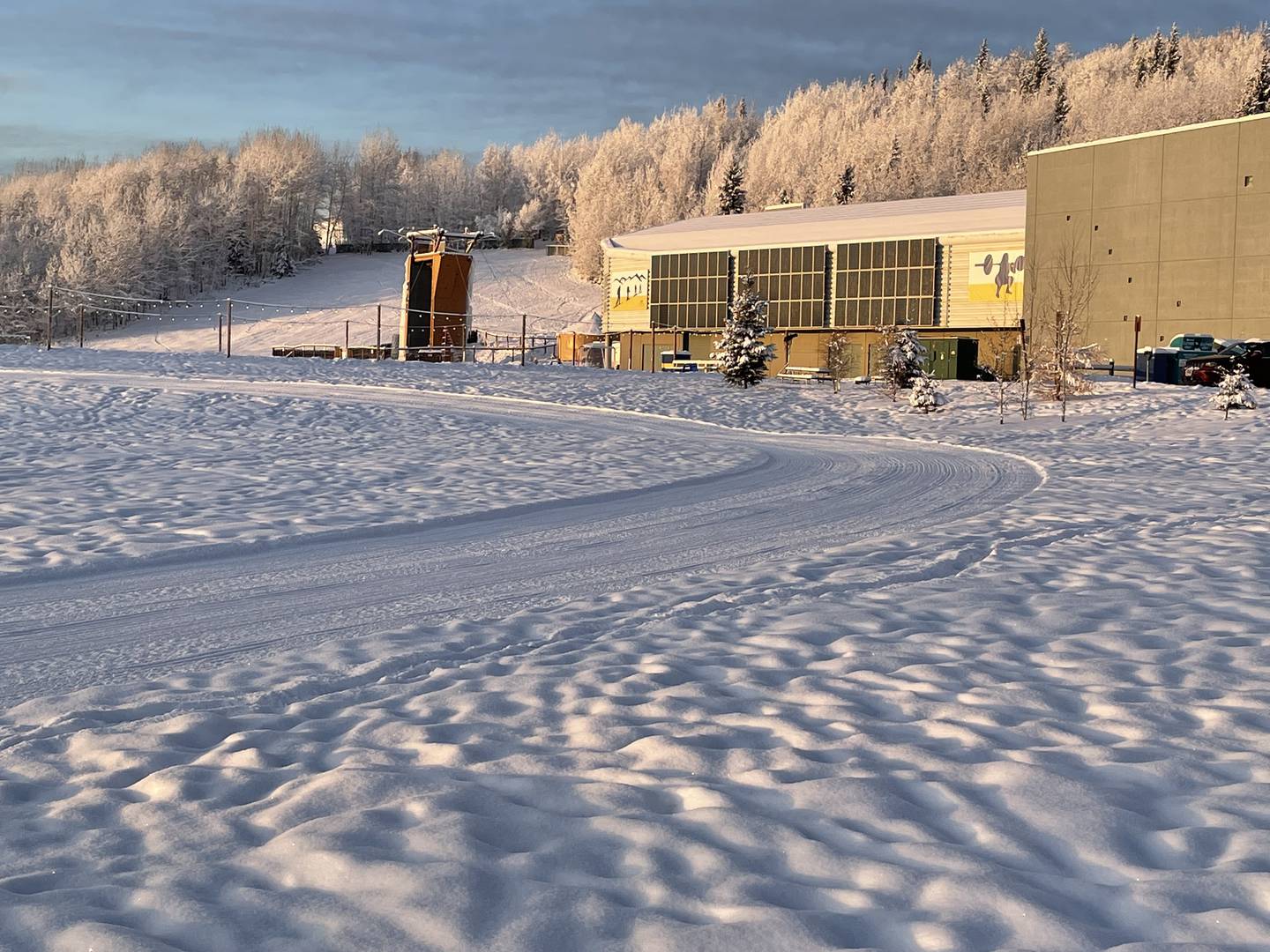December sunshine lights a freshly groomed cross-country ski trail and the Student Recreation Center at the University of Alaska Fairbanks