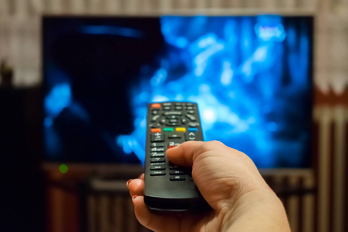 Stock – watching tv using remote