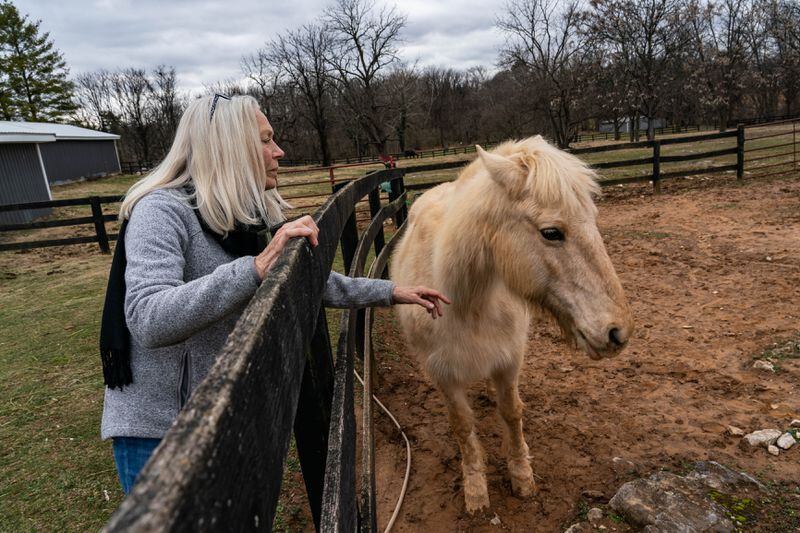 Robin Huyett Thomas reaches out to her horse, Lydia, on her property in Charles Town. (Salwan Georges/The Washington Post)
