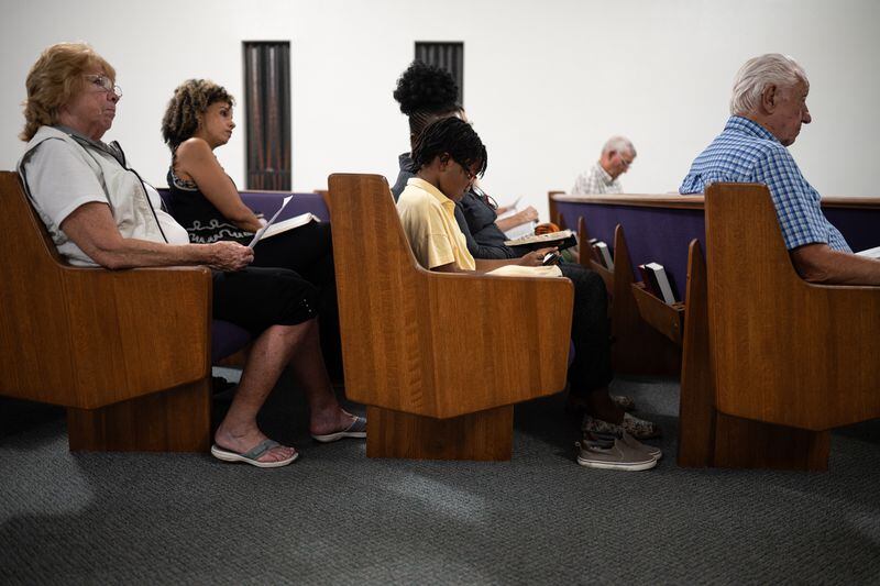 Kali Fontanilla, second from left, and other members of the couple’s Seventh-day Adventist church listen as her husband Joshua Fontanilla delivers a Friday night Bible lesson. Thomas Simonetti for The Washington Post