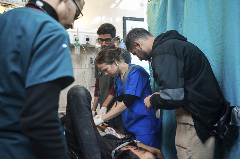 Pediatrician Tanya Haj-Hassan, center, examines wounded children at Al-Aqsa Martyrs Hospital in Deir al-Balah, central Gaza. Saturday, March 16, 2024. (AP Photo/Abdel Kareem Hana)