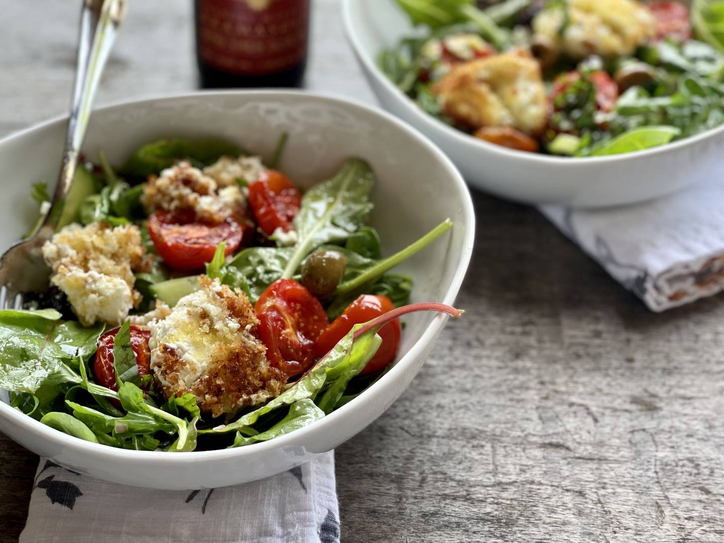 Crispy goat cheese salad with honey roasted tomato and olive