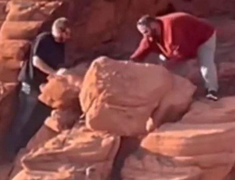In a video posted to social media, two men are seen pushing natural rock formations from a cliff at Redstone Dunes Trail area at Lake Mead National Recreation Area. (via National Park Service)