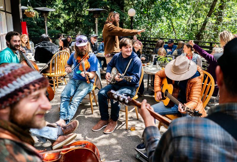 Nicholas Leahy, center, plays with other musicians at Pfeiffer State Park on April 6. Community gatherings, with free pizza, are one way Big Sur residents are coping with the closure of Highway 1. 
