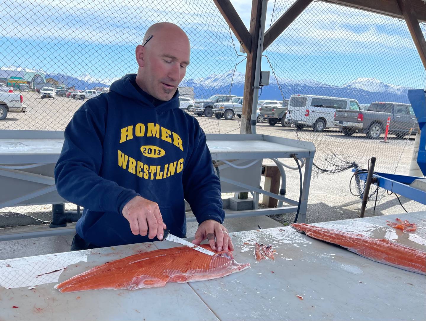 Homer’s Chris Perk filets a king salmon he caught in Kachemak Bay