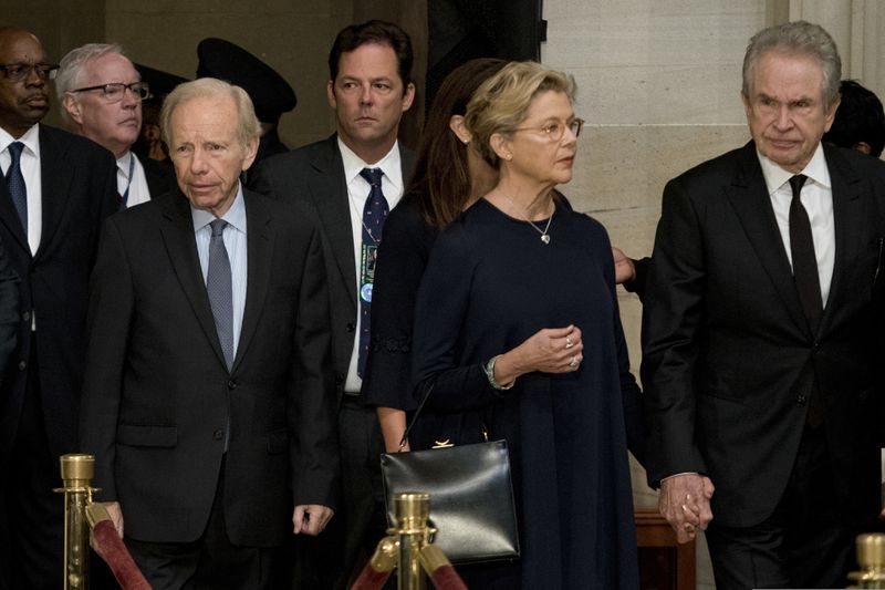 Former Connecticut Sen. Joe Lieberman, left, and actors Warren Beatty, right, and his wife Annette Bening, second from right, arrive in the Rotunda before the casket of Sen. John McCain, R-Ariz., lies in state at the U.S. Capitol, Friday, Aug. 31, 2018, in Washington. (AP Photo/Andrew Harnik, Pool)
