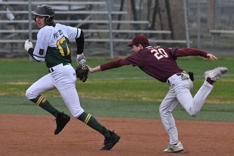 Dimond shortstop Hudson Willis tags out Service baserunner Andrew Hickman he attempts to run to third base Wednesday evening. (Bill Roth / ADN)