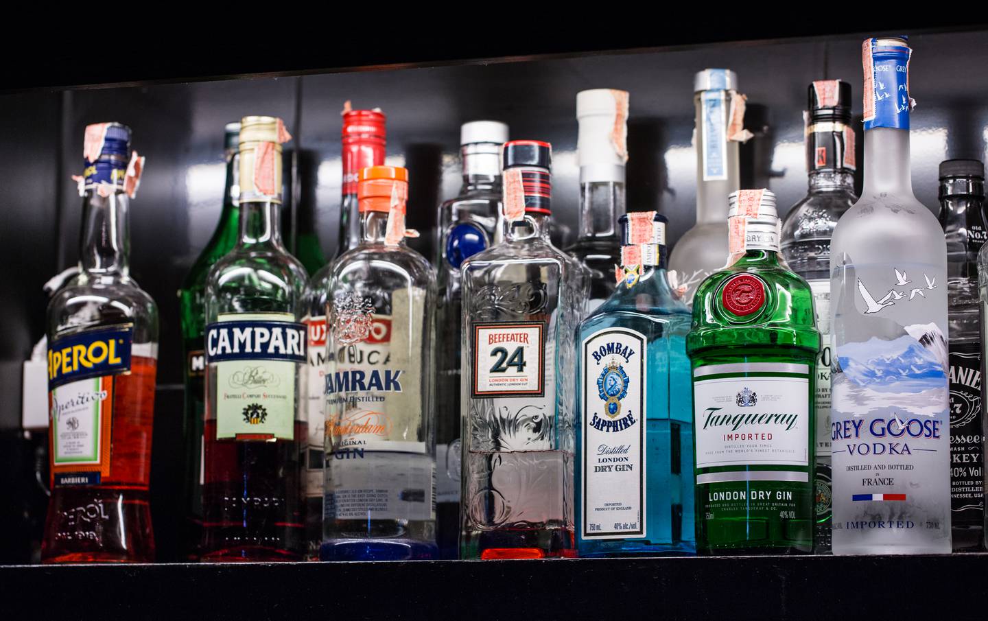 alcohol bottles on shelf for cocktails