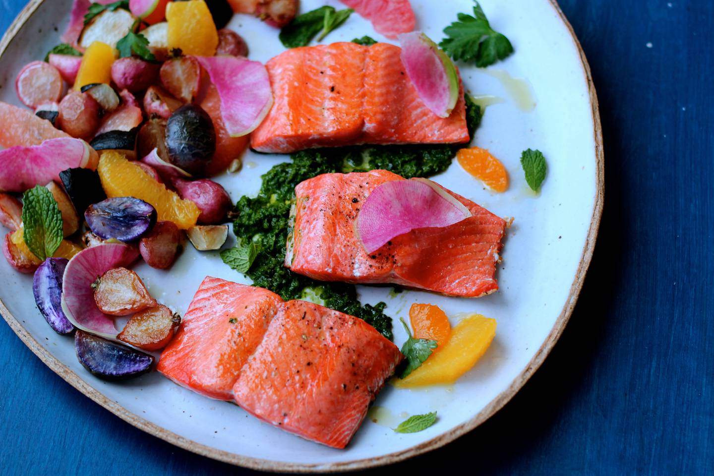 Pan-seared salmon with citrus, brown butter radishes and green herb sauce