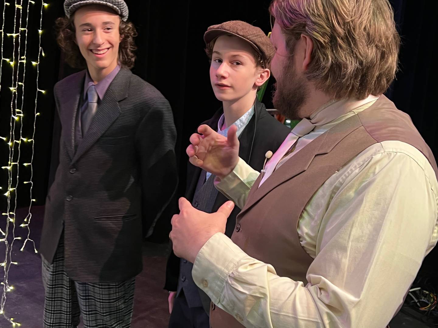 Todd Baer, right, who plays Cornelius Hackl in the TBA Theatre production of "Hello, Dolly!" talks to ensemble members Stevie Bahner and Wade Nyquist