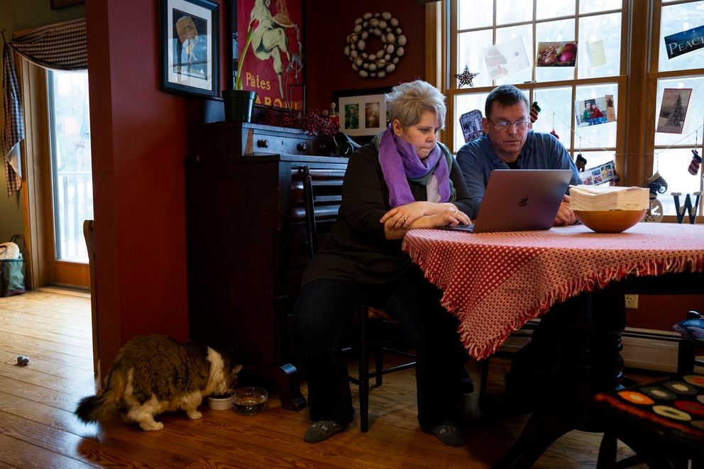 Kat Barrell, 49, and her husband Chris, 54, go over their bills and budgets at home in Newport, N.H., on Feb. 2, 2020. MUST CREDIT: Photo for The Washington Post by Elizabeth Frantz