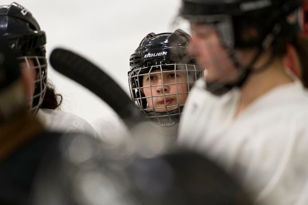 Alicia Prieto, 16, huddles with players on the South/Bartlett and Chugiak/Eagle River teams on January 26, 2019. Prieto is from Galicia, Spain. (Marc Lester / ADN)