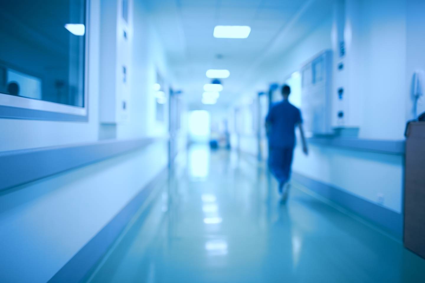 Stock - Hospital corridor and doctor as a blurred defocused background