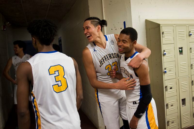 Kamaka Hepa, center, celebrates a win over a rival Portland team on Feb. 16, 2018. Teammate K’lum Strickland is at right and Jalen Brown is at left. (Marc Lester / ADN)
