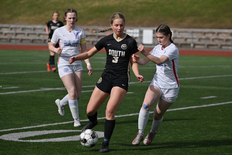 Ali Adkins of South moves the ball past defenders during the Wolverines' 7-0 home shutout against the Bettye Davis East High Thunderbirds on Tuesday, May 7, 2024. (Bill Roth / ADN)