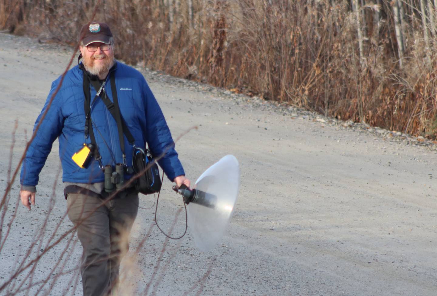 Doug Wacker walks a Fairbanks road last fall while pursuing ravens