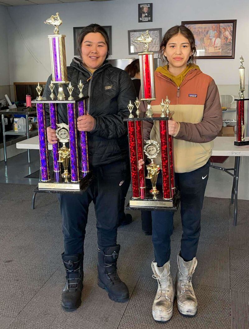 (From left) Sisters Samantha and Esther Skin from Selawik both raced and received awards for Gunner 120 snowmachine race. Photo by Rose Stalker.