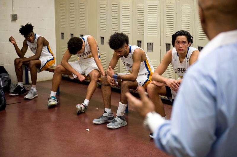 Jefferson basketball coach Pat Strickland speaks to Kamaka Hepa and his teammates at halftime of a game against Portland’s Cleveland High School. (Marc Lester / ADN)