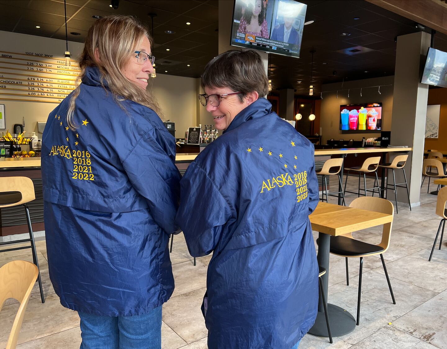 Two travelers pose with their “John Hall’s Alaska” jackets