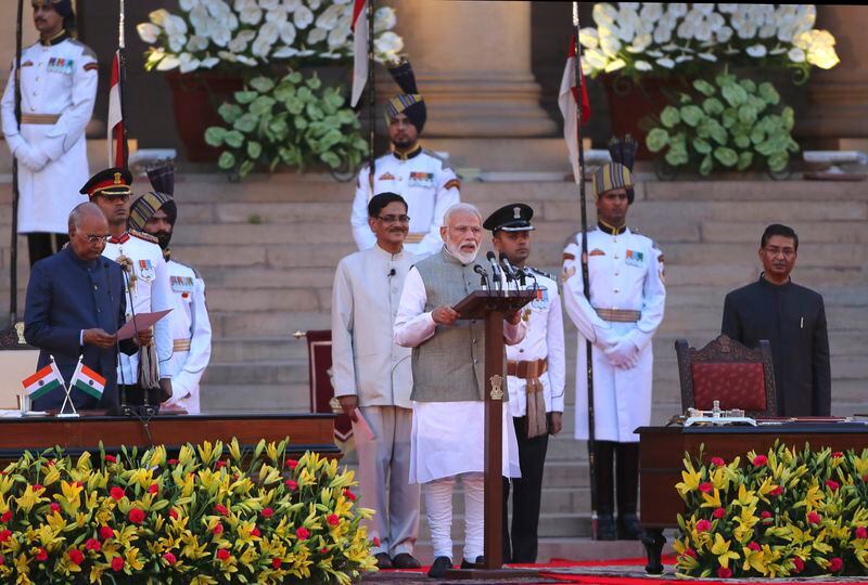 Indian President Ram Nath Kovind, left, administers an oath to Narendra Modi for a second term as India's prime minister during a swearing in ceremony at the presidential palace in New Delhi, India, May 30, 2019. Modi is campaigning for a third term in the general election starting Friday. (AP Photo/Manish Swarup)