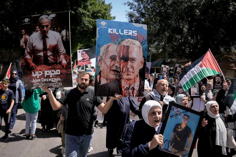 Palestinians hold photographs of prisoners jailed in Israel and posters depicting Israeli Prime Minister Benjamin Netanyahu and U.S. President Joe Biden, during a rally marking the annual prisoners' day in the West Bank city of Nablus, Wednesday, April 17, 2024. (AP Photo/Majdi Mohammed)