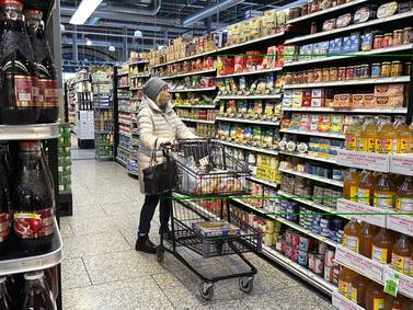 Led by lower food and auto prices, inflation cooled slightly last month