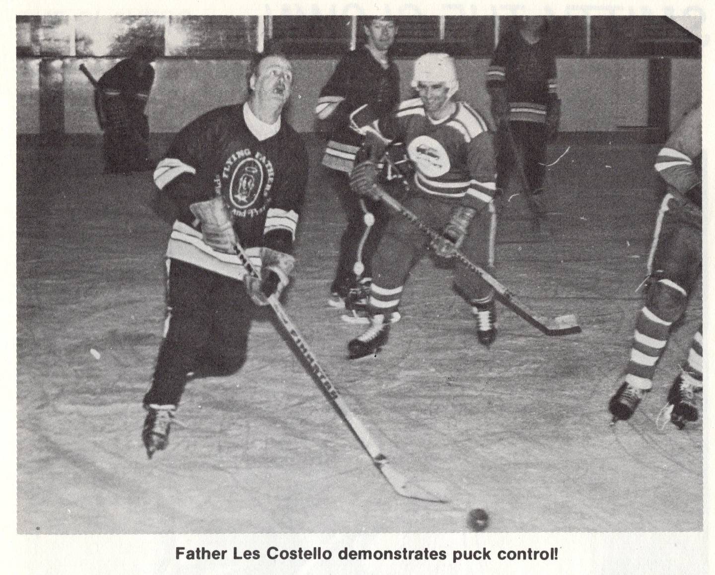 Father Les Costello handles the puck