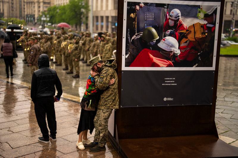 An army comrade is comforted as he cries during the funeral ceremony of Ukrainian army paramedic Nazarii Lavrovskyi, 31, killed in the war, at Independence square in Kyiv, Wednesday, April 24, 2024. Lavrovskyi, who served in the 244th battalion of the 112th Separate Territorial Defense Brigade, was killed April 18 while helping to evacuate wounded troops from the frontline in the Kharkiv area of eastern Ukraine. (AP Photo/Francisco Seco)