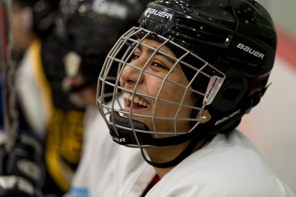 South/Bartlett hockey player Leena Tarar, of Khewra, Pakistan, laughs with teammates on the bench during a game on January 26, 2019. (Marc Lester / ADN)