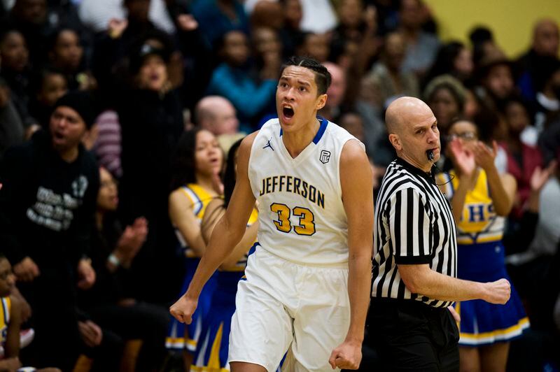 Power forward Kamaka Hepa celebrates Jefferson High’s play in front of a capacity crowd at the school on Feb. 16, 2018. (Marc Lester / ADN)