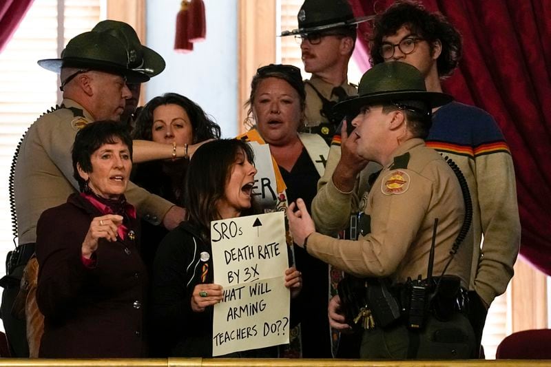 People in the gallery of the House chamber are removed by state troopers after a bill allowing some teachers to be armed in schools passes during a legislative session Tuesday, April 23, 2024, in Nashville, Tenn. (AP Photo/George Walker IV)