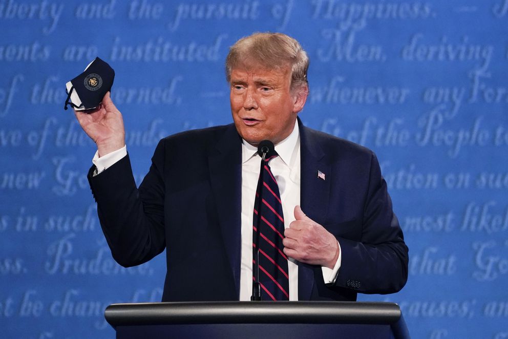 In this Sept. 29, 2020, photo, President Donald Trump holds up his face mask during the first presidential debate at Case Western University and Cleveland Clinic, in Cleveland, Ohio.(AP Photo/Julio Cortez, File)