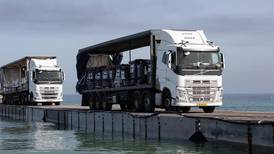 Trucks are delivering aid across a new pier into Gaza, but challenges to distribution remain