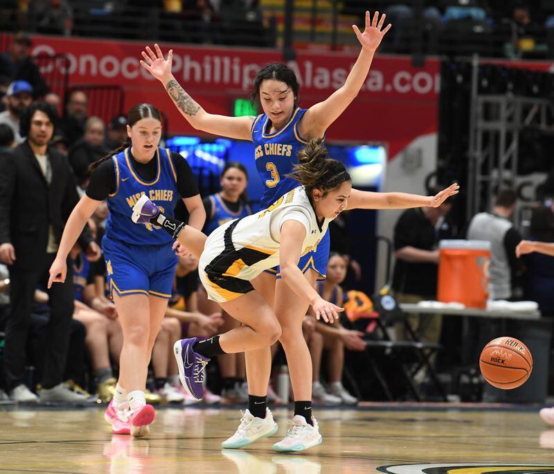 Kennedy Cook, of Metlakatla, defends as Jennifer Nash, of Tikigaq, goes airborne in the 2A girls state basketball championship game at the Alaska Airlines Center in Anchorage on Saturday, March 16, 2024. Metlakatla won the championship game 51-42. (Bob Hallinen Photo)