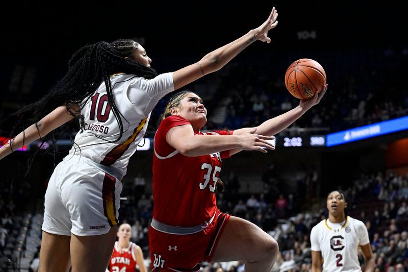Utah forward Alissa Pili (35) shoots as South Carolina center Kamilla Cardoso (10) defends in the second half of an NCAA college basketball game, Sunday, Dec. 10, 2023, in Uncasville, Conn. (AP Photo/Jessica Hill)