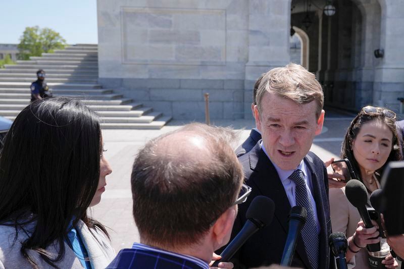 Sen. Michael Bennet, D-Colo., center, speaks to reporters outside the U.S. Capitol, Tuesday, April 23, 2024, in Washington as Senators prepare to consider legislation that would force TikTok's China-based parent company to sell the social media platform under the threat of a ban. (AP Photo/Mariam Zuhaib)
