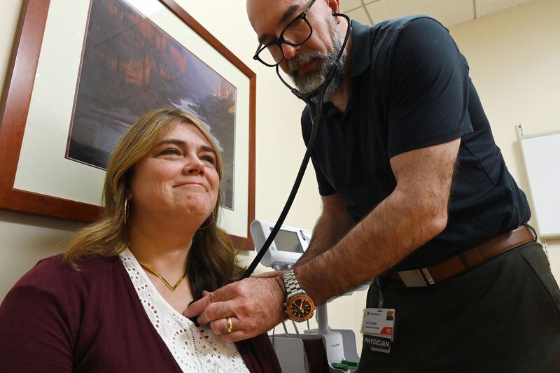 Elishaba Doerksen is examined by radiation oncologist Stephen Settle after she received radiotherapy on April 18. (Bill Roth / ADN)