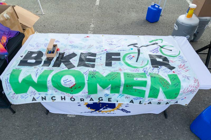 Participants signed a banner in honor of Diane Mohwinkel during the 2024 Bike for Women event. (Photo by Andy Romang)